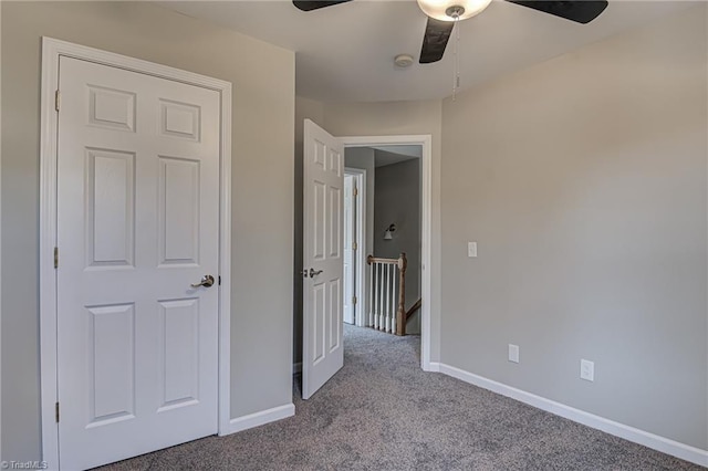 unfurnished bedroom with ceiling fan and light colored carpet