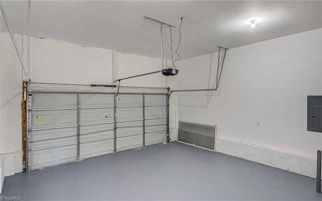 garage with electric panel and a garage door opener