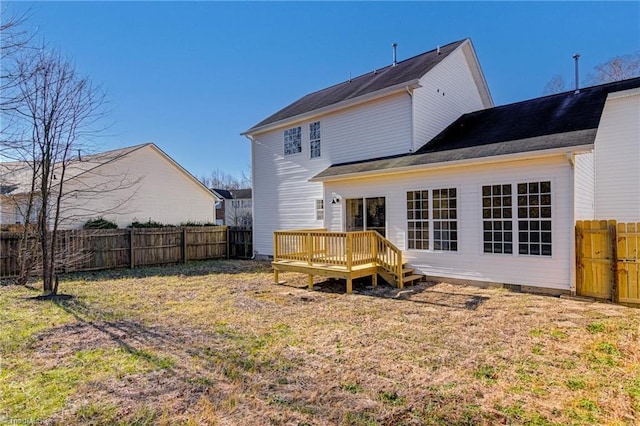 rear view of house featuring a yard and a wooden deck