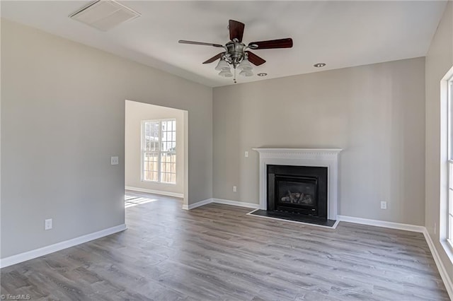 unfurnished living room featuring light hardwood / wood-style flooring and ceiling fan