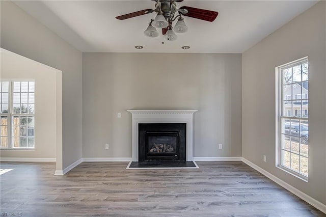 unfurnished living room with ceiling fan and light hardwood / wood-style floors