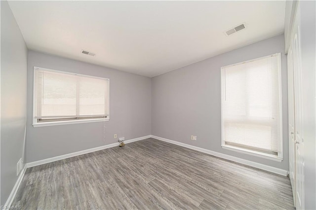 empty room featuring wood finished floors and baseboards
