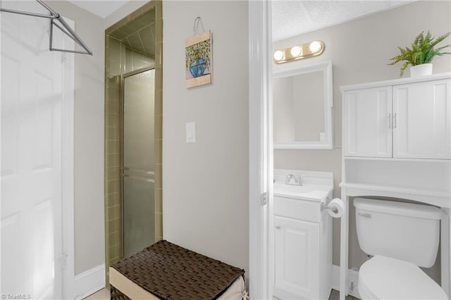 bathroom with vanity, toilet, and an enclosed shower