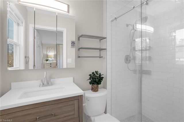 bathroom with vanity, an enclosed shower, and toilet