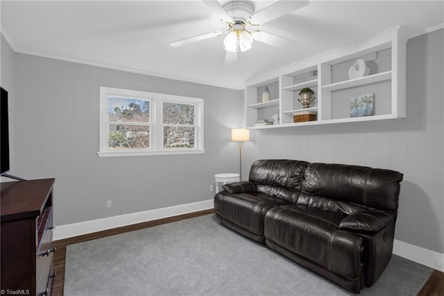 living room with built in shelves, ceiling fan, ornamental molding, and hardwood / wood-style floors