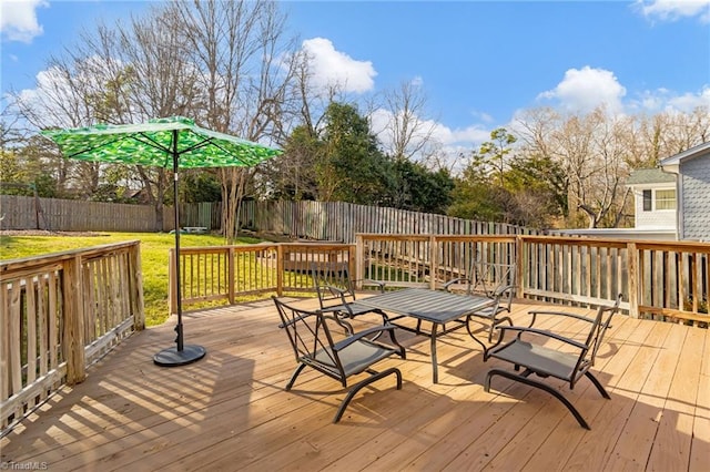 wooden terrace with a lawn