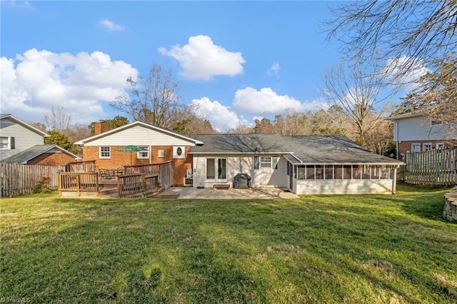 back of house with a sunroom, a yard, a deck, and a patio area