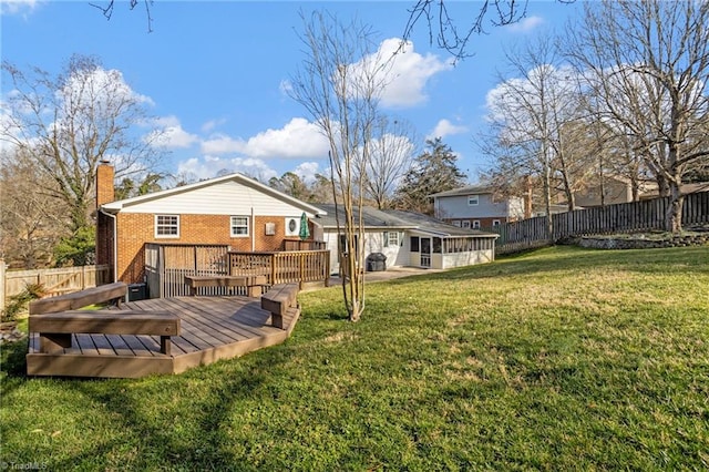 back of property featuring a yard and a deck