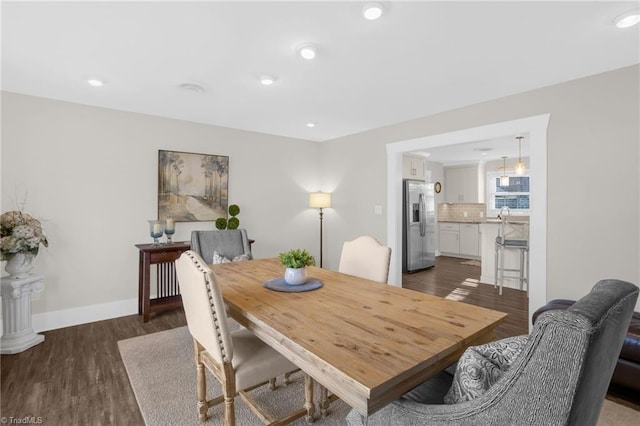 dining area with dark wood-type flooring