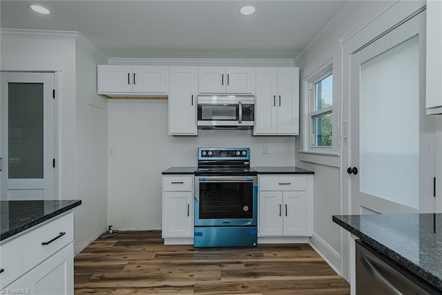 408 N Maple St, Graham, NC 27253 - kitchen featuring appliances with stainless steel finishes, recessed lighting, ornamental molding, white cabinets, and dark wood-style flooring