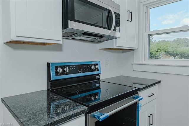 408 N Maple St, Graham, NC 27253 - kitchen featuring appliances with stainless steel finishes, white cabinets, and dark stone countertops
