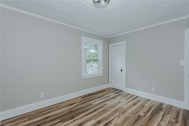 408 N Maple St, Graham, NC 27253 - empty room with wood finished floors, crown molding, and baseboards