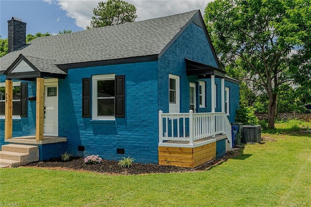 408 N Maple St, Graham, NC 27253 - view of front facade featuring central air condition unit, crawl space, brick siding, a chimney, and roof with shingles