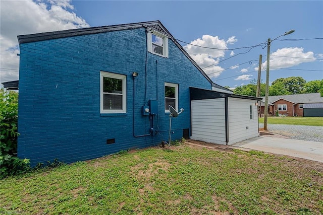 408 N Maple St, Graham, NC 27253 - view of side of home with a lawn, brick siding, and crawl space