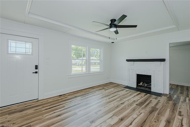 408 N Maple St, Graham, NC 27253 - unfurnished living room featuring a tray ceiling, wood finished floors, ornamental molding, a fireplace, and ceiling fan