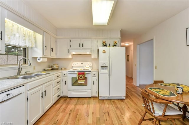 kitchen featuring sink, white cabinets, white appliances, and light wood-type flooring