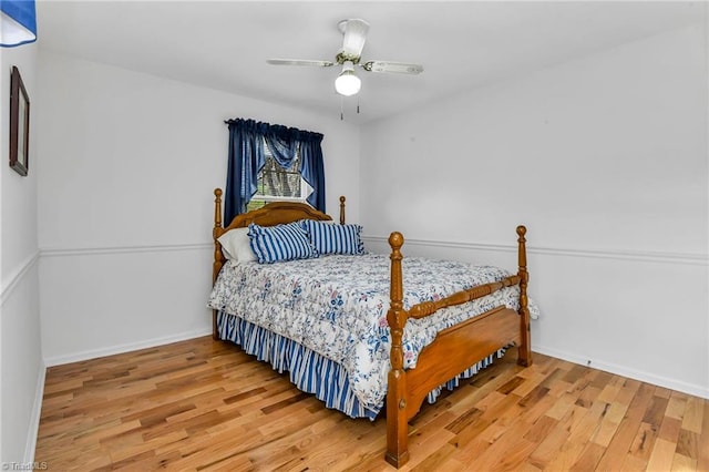 bedroom with hardwood / wood-style floors and ceiling fan