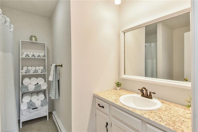 bathroom with tile patterned flooring, vanity, and baseboard heating