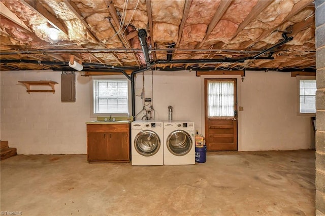 washroom featuring washer and dryer, electric panel, and cabinets