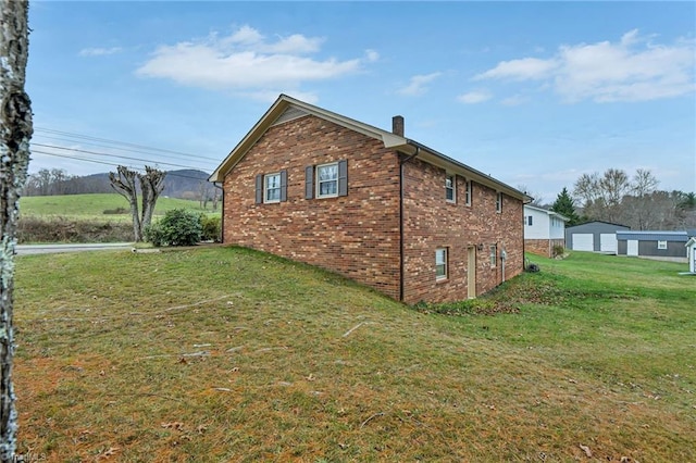 view of side of home featuring a lawn