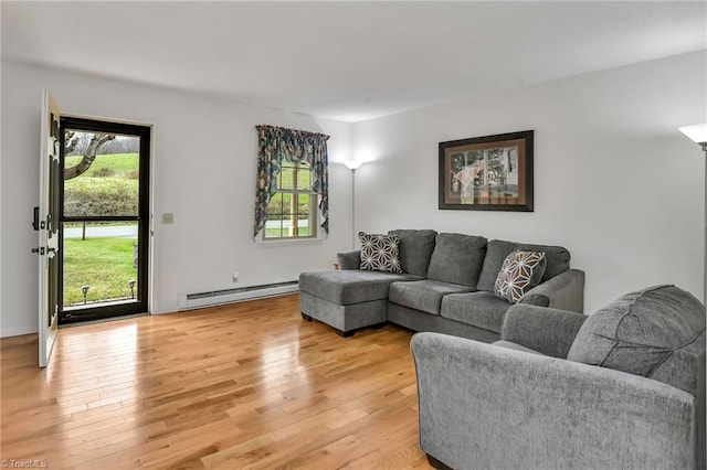 living room featuring baseboard heating and light wood-type flooring