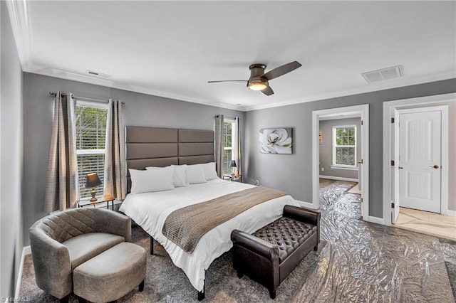 bedroom featuring multiple windows, ornamental molding, and ceiling fan