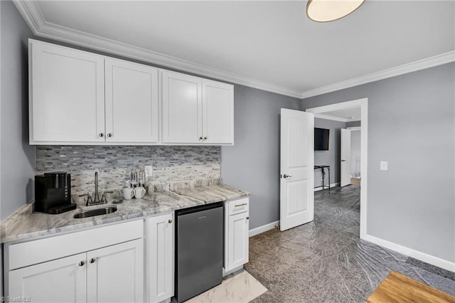 kitchen featuring sink, crown molding, fridge, white cabinets, and backsplash