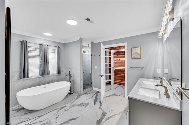 bathroom featuring plus walk in shower, vanity, and crown molding