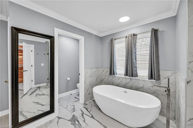 bathroom with crown molding, a washtub, and toilet