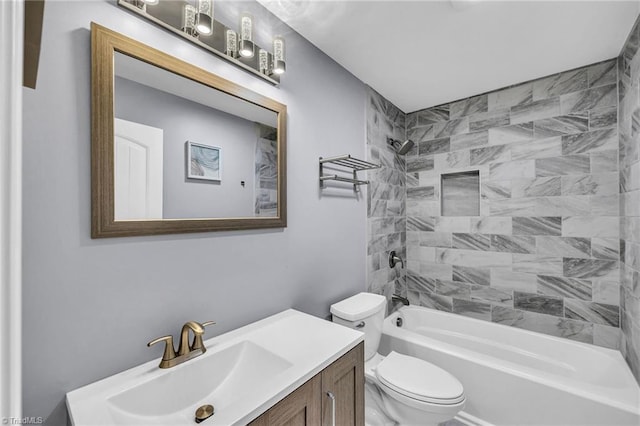 full bathroom featuring vanity, tiled shower / bath combo, and toilet