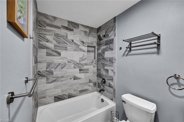 bathroom featuring tiled shower / bath and toilet