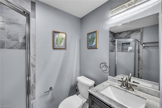 bathroom with vanity, toilet, and walk in shower