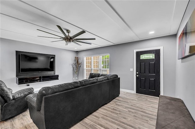 living room featuring ceiling fan and light wood-type flooring