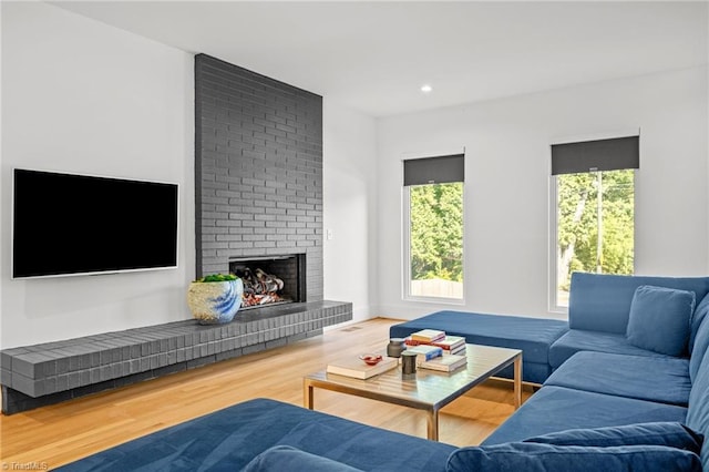 living room with a fireplace, hardwood / wood-style flooring, and plenty of natural light