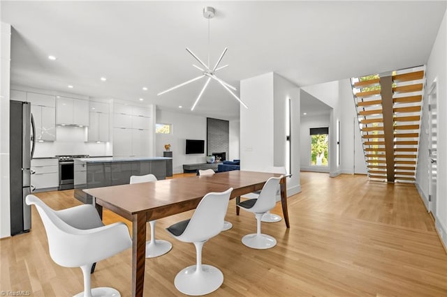 dining area featuring a notable chandelier and light hardwood / wood-style floors