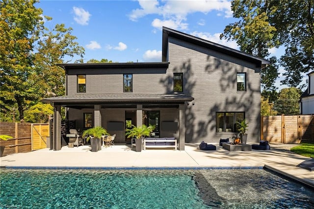 back of house featuring a patio area and a fenced in pool