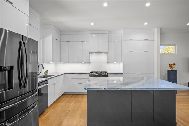 kitchen featuring white cabinetry, stainless steel appliances, and a center island