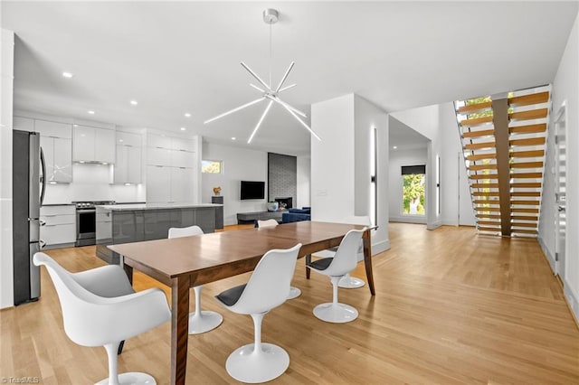 dining room featuring light hardwood / wood-style flooring and a notable chandelier