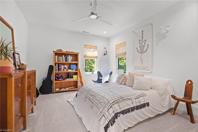 bedroom featuring light carpet and ceiling fan