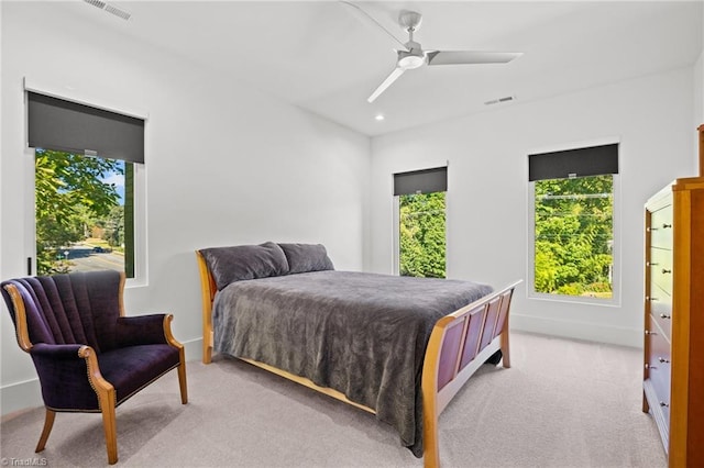 bedroom featuring light colored carpet and ceiling fan