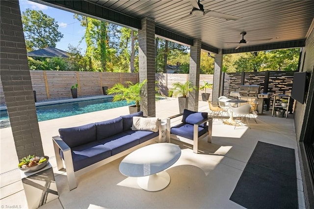 view of patio / terrace featuring a fenced in pool, outdoor lounge area, and ceiling fan