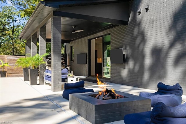 view of patio with a fire pit and ceiling fan