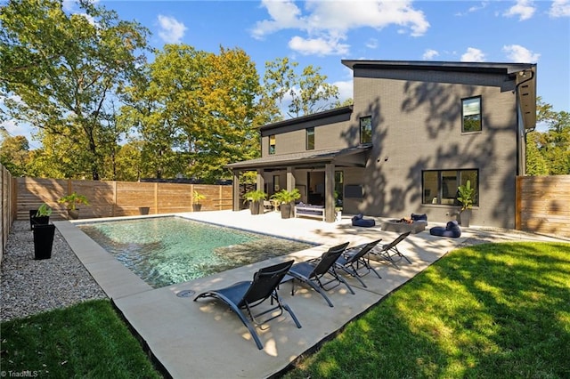 view of swimming pool featuring a patio and a yard