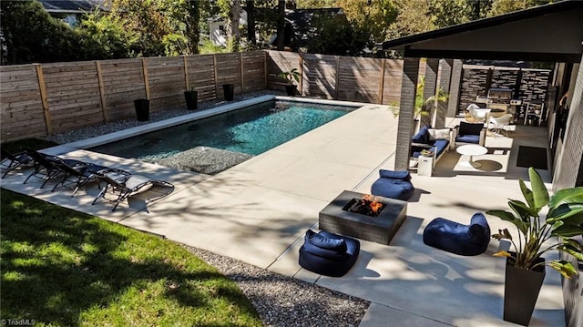 view of pool with a patio and a fire pit