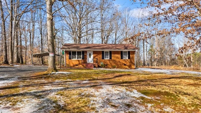 ranch-style house with a carport and a front lawn