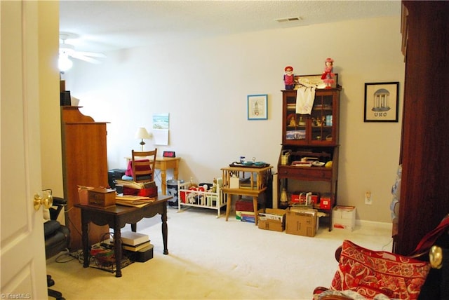 office with carpet, a ceiling fan, and visible vents