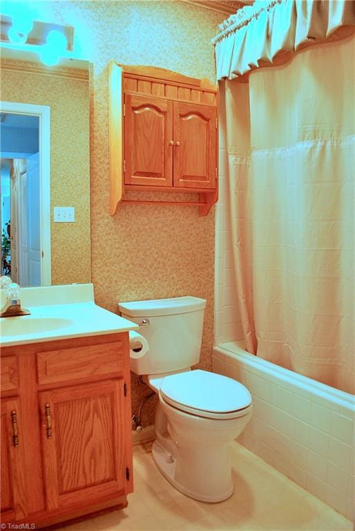 full bath with shower / bath combo with shower curtain, toilet, and vanity