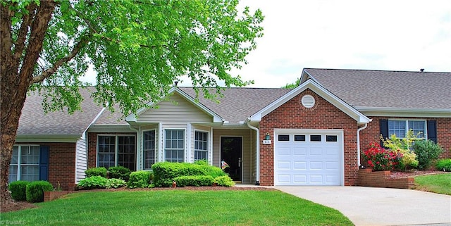 ranch-style house featuring a front lawn, driveway, brick siding, and a garage