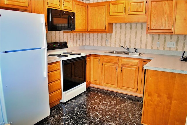 kitchen with freestanding refrigerator, electric range oven, a sink, black microwave, and light countertops