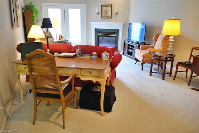 interior space featuring a glass covered fireplace and carpet floors